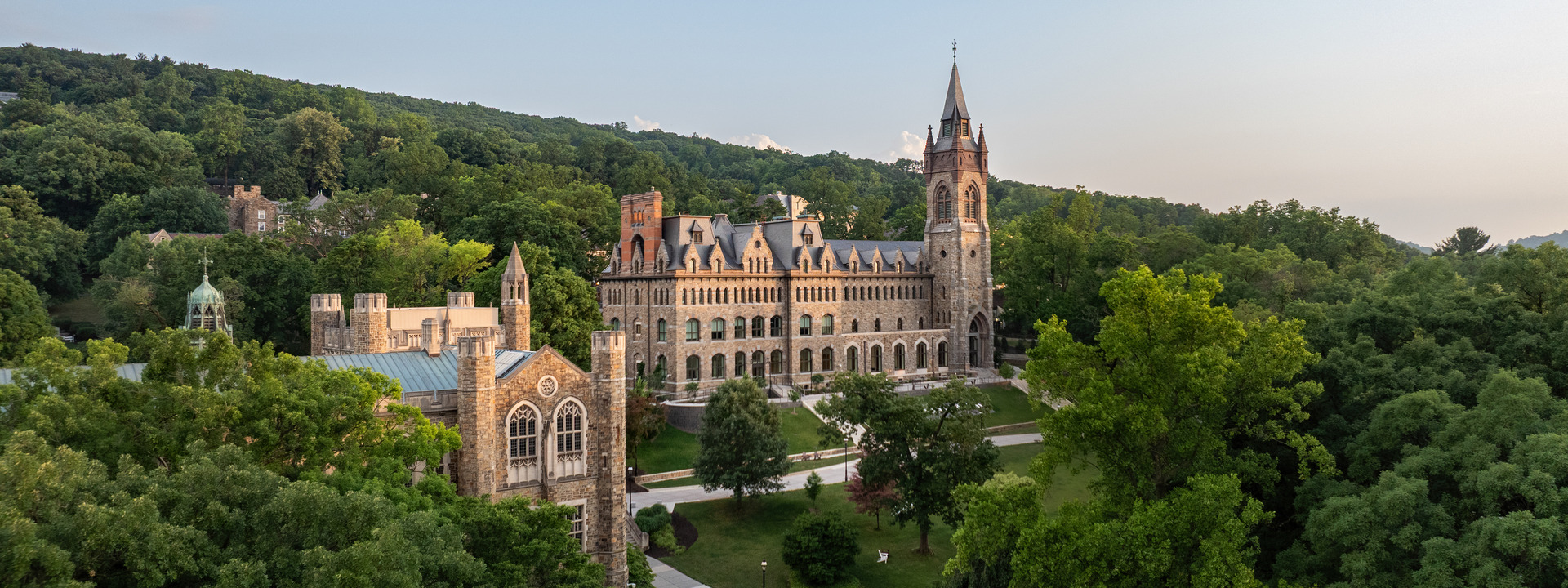 aerial view of two iconic Lehigh University buildings, the Clayton University Center and Linderman Library, nestled in the lush green setting of South Mountain